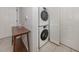 Laundry area featuring a stacked washer and dryer and storage cabinet at 100 Central Ave # C521, Sarasota, FL 34236