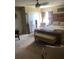 This primary bedroom features neutral carpeting, a large ceiling fan and a king-size bed with bench at 10157 Sunburst Ct, Spring Hill, FL 34608