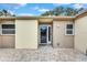 Close-up of the home's front door, showcasing a tiled entrance and modern exterior lighting at 111 Whispering Sands Cir # V38, Sarasota, FL 34242