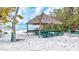 Enjoy the peacefulness of this tiki hut sitting on the beach, offering a shaded space for relaxation at 111 Whispering Sands Cir # V38, Sarasota, FL 34242