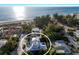 Aerial view of a home with a metal roof, a pool, and stunning beach views at 112 50Th St, Holmes Beach, FL 34217