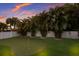 Backyard with a putting green, palm trees and privacy fence at 112 50Th St, Holmes Beach, FL 34217