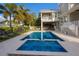 Beautiful backyard featuring a large pool, lounge area, and lush tropical landscaping at 112 50Th St, Holmes Beach, FL 34217