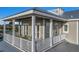 Exterior balcony with white railings and comfortable seating with beautiful trim at 112 50Th St, Holmes Beach, FL 34217