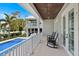 Inviting balcony overlooking the pool and backyard, complete with comfortable rocking chairs at 112 50Th St, Holmes Beach, FL 34217