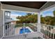 Balcony view of pool, backyard landscaping, and neighboring home at 112 50Th St, Holmes Beach, FL 34217