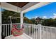 Balcony with a colorful, comfortable hammock swing and a view of lush landscaping at 112 50Th St, Holmes Beach, FL 34217