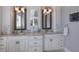Bright bathroom featuring double vanities, granite countertops, and framed mirrors at 112 50Th St, Holmes Beach, FL 34217