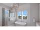 Bathroom with a standalone tub, tiled shower, and modern fixtures at 112 50Th St, Holmes Beach, FL 34217