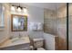 Bathroom featuring tiled walk-in shower, white vanity, modern fixtures, and decorative accent tiles at 112 50Th St, Holmes Beach, FL 34217