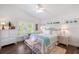 Bright bedroom with white furniture, wood flooring, and natural light from the window at 112 50Th St, Holmes Beach, FL 34217