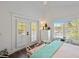 Bedroom showcasing a queen-sized bed, bench, and glass doors to a balcony at 112 50Th St, Holmes Beach, FL 34217