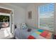 Cozy bedroom features a twin bed and access to a balcony with a hanging hammock at 112 50Th St, Holmes Beach, FL 34217