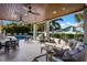 Spacious covered patio with ceiling fans, dining and lounge seating and views of the swimming pool at 112 50Th St, Holmes Beach, FL 34217