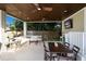 Inviting covered patio with comfortable seating, dining area, and wood plank ceiling at 112 50Th St, Holmes Beach, FL 34217