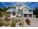 Charming home with lush front lawn, garage, and welcoming covered porch at 112 50Th St, Holmes Beach, FL 34217