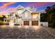 Spectacular two-story coastal home with a rooftop terrace, two-car garage, and a paver driveway at 112 50Th St, Holmes Beach, FL 34217