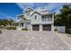 Beautiful home boasts two-car garage, multiple balconies and Craftsman-style details at 112 50Th St, Holmes Beach, FL 34217