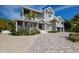 Landscaped front exterior showing the facade, garage, driveway, and covered porch at 112 50Th St, Holmes Beach, FL 34217