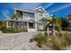 Attractive two-story home with brick driveway, covered porch and professional landscaping at 112 50Th St, Holmes Beach, FL 34217