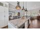 Modern kitchen features a large island, seamlessly flowing into the living space at 112 50Th St, Holmes Beach, FL 34217