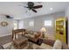 Cozy living room area with wicker furniture, ceiling fans, foosball table, and bright yellow shelving at 112 50Th St, Holmes Beach, FL 34217