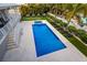 Aerial view of backyard featuring a pool, hot tub, putting green and lounge chairs at 112 50Th St, Holmes Beach, FL 34217