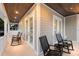 Relaxing outdoor space with rocking chairs, a tiled floor, and a stained wood ceiling at 112 50Th St, Holmes Beach, FL 34217