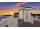 Relaxing rooftop deck with comfortable seating, perfect for enjoying panoramic ocean views and beautiful sunsets at 112 50Th St, Holmes Beach, FL 34217