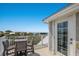Relaxing rooftop deck with outdoor furniture, scenic views, and access to the house at 112 50Th St, Holmes Beach, FL 34217