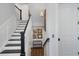 Elegant stairway with white risers, dark wood treads, and decorative wall art with a seashell theme at 112 50Th St, Holmes Beach, FL 34217