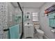 Bathroom with vanity and shower featuring stylish grey tiling and modern fixtures at 1210 67Th Street E Ct, Bradenton, FL 34208