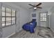 Cozy bedroom featuring a ceiling fan, a large window, and plush carpeting at 1210 67Th Street E Ct, Bradenton, FL 34208