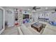 Bright living room with coastal decor, built-in shelving, and gray wood-look flooring at 1210 67Th Street E Ct, Bradenton, FL 34208