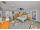 Spacious main bedroom featuring a large bed, natural lighting, and gray wood-look floors at 1210 67Th Street E Ct, Bradenton, FL 34208