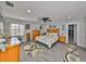 Main bedroom featuring a large bed, natural lighting, and gray wood-look floors at 1210 67Th Street E Ct, Bradenton, FL 34208