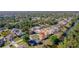 Overhead view of houses near water with large, verdant tree coverage in the neighborhood at 1224 Inverness St, Port Charlotte, FL 33952