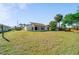 Spacious backyard offering a large grassy area and partial perimeter fencing at 1224 Inverness St, Port Charlotte, FL 33952
