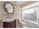Well-lit bathroom featuring modern fixtures, vanity, and a shower-tub combo with glass doors at 1224 Inverness St, Port Charlotte, FL 33952