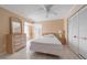 Cozy bedroom featuring tile floors, a ceiling fan, and ample closet space for storage at 1224 Inverness St, Port Charlotte, FL 33952