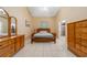 Bright and airy bedroom with tile floors, a ceiling fan, and traditional wooden furniture at 1224 Inverness St, Port Charlotte, FL 33952