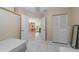 Bedroom features tile floors, white closets and doors, and an open door to the living room at 1224 Inverness St, Port Charlotte, FL 33952