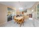 Bright dining area features a wooden table, tile flooring, and seamless access to the lanai through sliding glass doors at 1224 Inverness St, Port Charlotte, FL 33952
