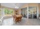 Well-lit dining area with backyard views and seamless flow to sunroom through sliding glass doors at 1224 Inverness St, Port Charlotte, FL 33952