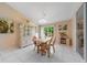 Dining area with wood table, four chairs, tile flooring, a sliding door and a china cabinet at 1224 Inverness St, Port Charlotte, FL 33952