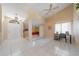 The bright entryway leads to the living room; it features tile floors, tan walls, and a ceiling fan at 1224 Inverness St, Port Charlotte, FL 33952