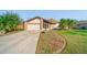 Inviting home with an attached garage, complemented by mature landscaping and a long driveway at 1224 Inverness St, Port Charlotte, FL 33952