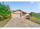 A home with an attached garage and a well maintained lawn at 1224 Inverness St, Port Charlotte, FL 33952