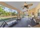 Bright sunroom featuring neutral color palettes, ceiling fans and views of the lush backyard at 1224 Inverness St, Port Charlotte, FL 33952