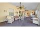 Relaxing sunroom featuring neutral decor, ceiling fans, and easy access to the dining area at 1224 Inverness St, Port Charlotte, FL 33952